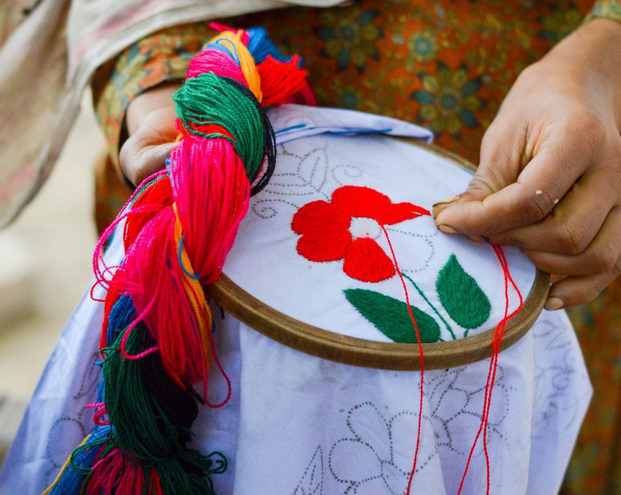 Hand embroidery by a Qambranis artisan